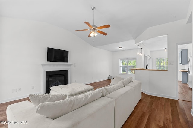 317 Inverness Dr, Hubert, NC 28539 - living area featuring ceiling fan, lofted ceiling, wood finished floors, baseboards, and a glass covered fireplace