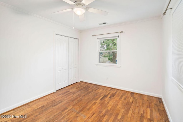 227 Rose Ave, Wilmington, NC 28403 - unfurnished bedroom featuring wood finished floors, crown molding, a closet, and a ceiling fan