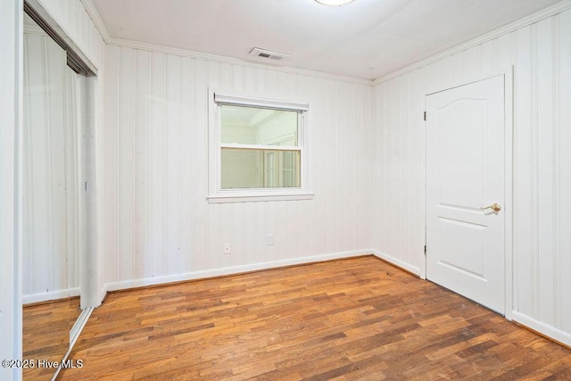 227 Rose Ave, Wilmington, NC 28403 - unfurnished bedroom with wood finished floors, ornamental molding, and a closet