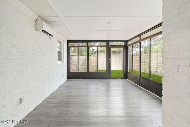 227 Rose Ave, Wilmington, NC 28403 - unfurnished sunroom featuring a wall mounted AC, brick wall, plenty of natural light, wood finished floors, and floor to ceiling windows