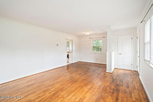 227 Rose Ave, Wilmington, NC 28403 - spare room with wood finished floors, crown molding, and washer / dryer