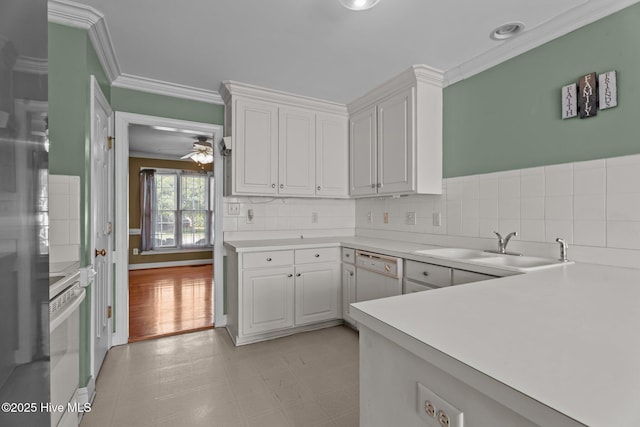 4710 Hudson Rd NW, Wilson, NC 27896 - kitchen featuring a sink, ornamental molding, dishwasher, white cabinetry, and light countertops