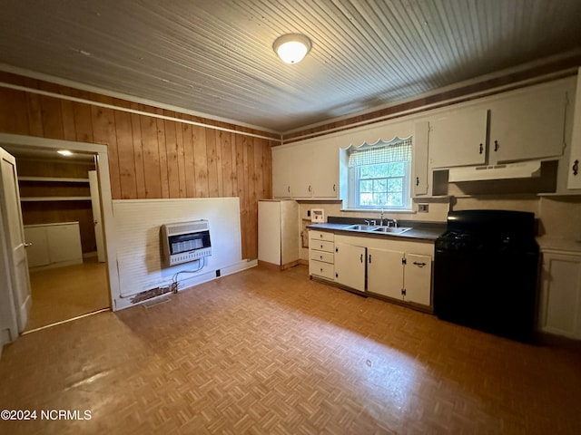 114 Rhodes Ave, Windsor, NC 27983 - kitchen with black range with gas cooktop, under cabinet range hood, heating unit, a sink, and wooden walls