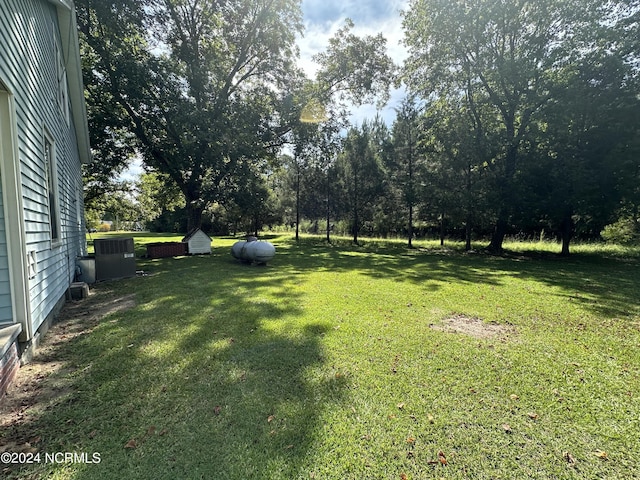 114 Rhodes Ave, Windsor, NC 27983 - view of grassy yard featuring central AC unit and view of scattered trees