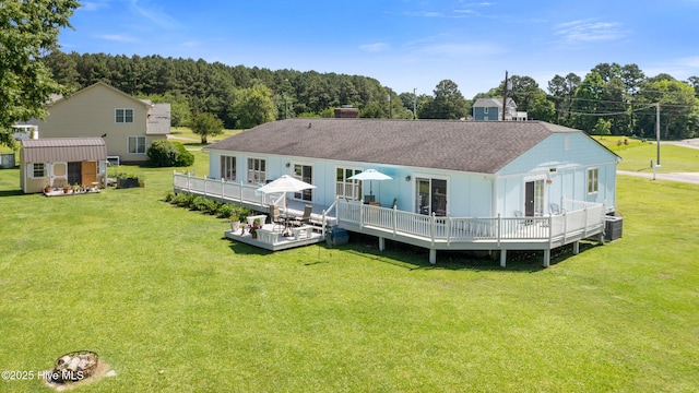 1235 Sound Shore Dr, Edenton, NC 27932 - rear view of property featuring a deck, a yard, an outbuilding, a chimney, and central AC unit