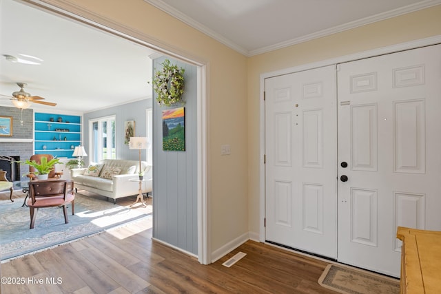 1235 Sound Shore Dr, Edenton, NC 27932 - foyer with wood finished floors, ornamental molding, baseboards, a fireplace, and a ceiling fan