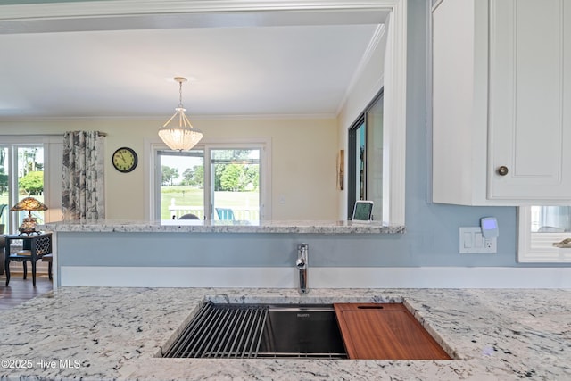 1235 Sound Shore Dr, Edenton, NC 27932 - kitchen featuring healthy amount of natural light, ornamental molding, white cabinetry, and light stone countertops