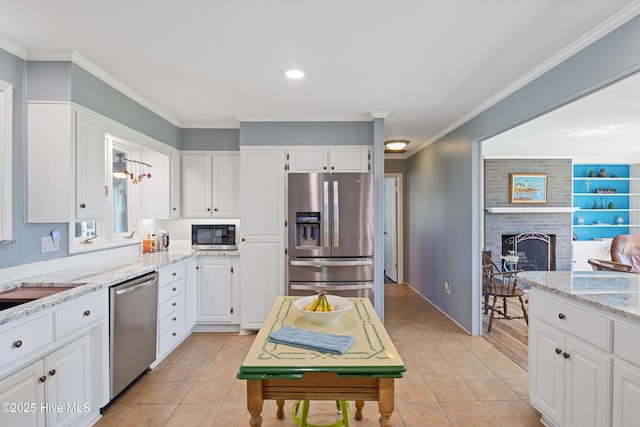 1235 Sound Shore Dr, Edenton, NC 27932 - kitchen featuring stainless steel appliances, white cabinetry, ornamental molding, light tile patterned floors, and light stone counters