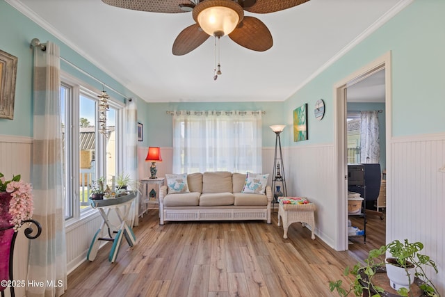 1235 Sound Shore Dr, Edenton, NC 27932 - living area featuring wainscoting, wood finished floors, ceiling fan, plenty of natural light, and ornamental molding