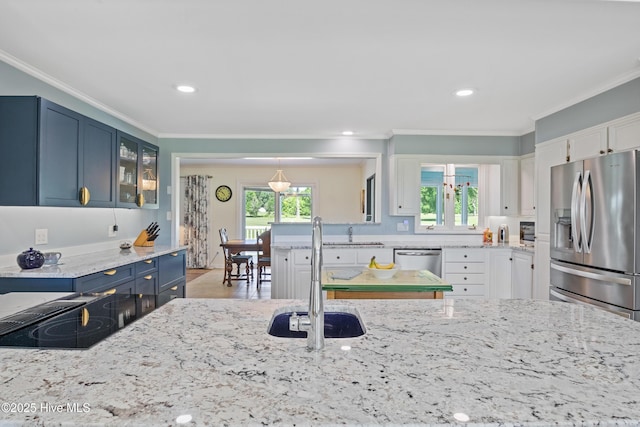 1235 Sound Shore Dr, Edenton, NC 27932 - kitchen with stainless steel appliances, a sink, light stone countertops, crown molding, and glass insert cabinets