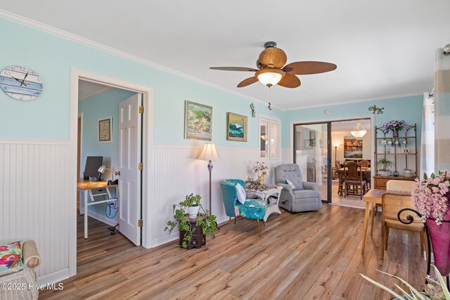 1235 Sound Shore Dr, Edenton, NC 27932 - sitting room featuring light wood-style floors, wainscoting, a ceiling fan, a desk, and ornamental molding