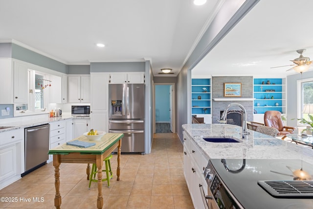 1235 Sound Shore Dr, Edenton, NC 27932 - kitchen featuring appliances with stainless steel finishes, a sink, white cabinets, light tile patterned floors, and crown molding