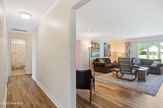 1235 Sound Shore Dr, Edenton, NC 27932 - living area featuring wood finished floors, crown molding, and baseboards