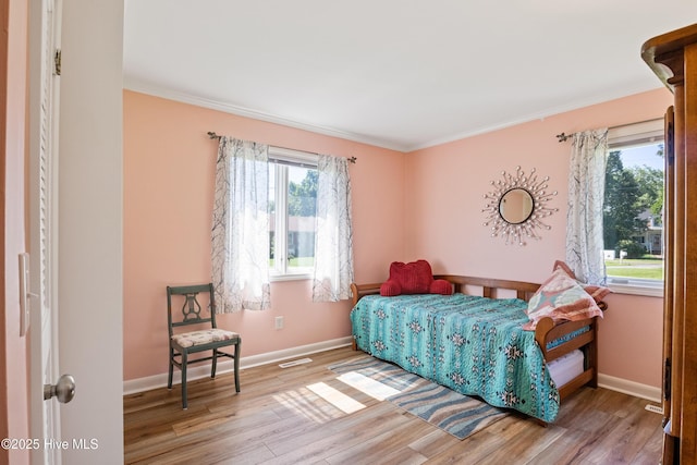 1235 Sound Shore Dr, Edenton, NC 27932 - bedroom featuring wood finished floors, crown molding, and baseboards