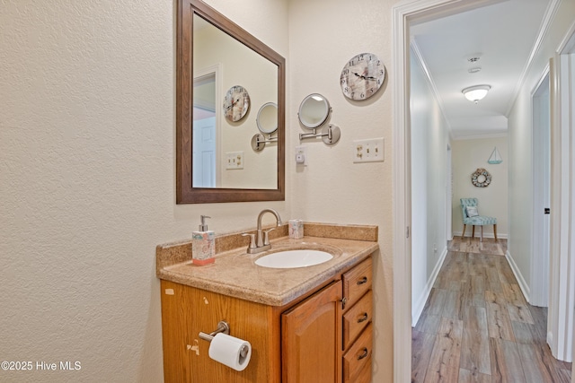 1235 Sound Shore Dr, Edenton, NC 27932 - bathroom with a textured wall, vanity, wood finished floors, ornamental molding, and baseboards