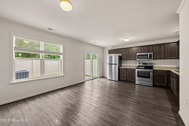 312 Glenellen Loop Rd, Midway Park, NC 28544 - kitchen with appliances with stainless steel finishes, light countertops, ornamental molding, dark brown cabinetry, and dark wood-style flooring