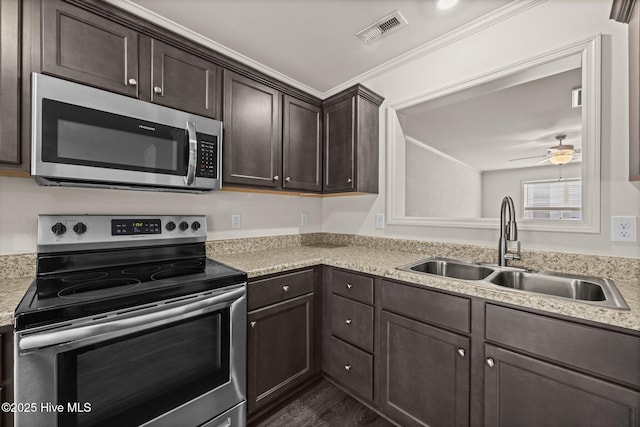 312 Glenellen Loop Rd, Midway Park, NC 28544 - kitchen with stainless steel appliances, a sink, dark brown cabinets, light countertops, and ceiling fan