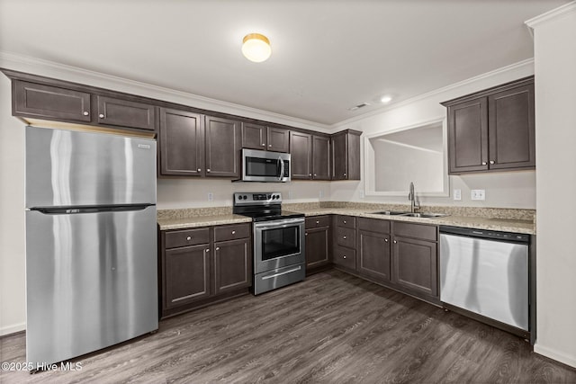 312 Glenellen Loop Rd, Midway Park, NC 28544 - kitchen featuring appliances with stainless steel finishes, a sink, dark brown cabinetry, dark wood-style flooring, and light countertops