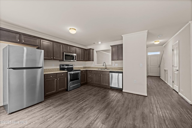 312 Glenellen Loop Rd, Midway Park, NC 28544 - kitchen with appliances with stainless steel finishes, a sink, dark brown cabinetry, dark wood-type flooring, and ornamental molding