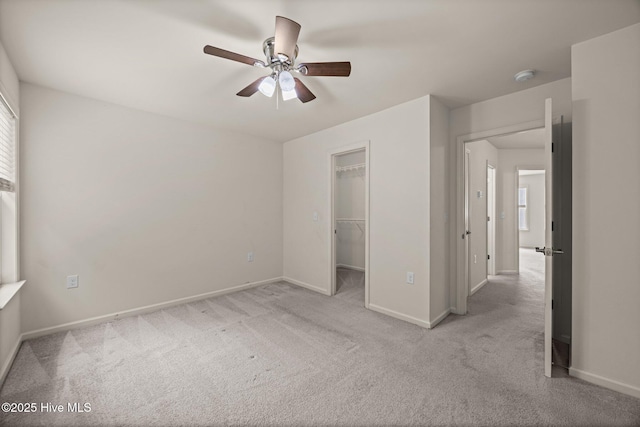 312 Glenellen Loop Rd, Midway Park, NC 28544 - unfurnished bedroom with a walk in closet, baseboards, carpet, and a ceiling fan