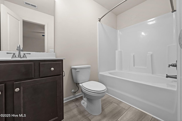 312 Glenellen Loop Rd, Midway Park, NC 28544 - bathroom with toilet, vanity, wood finished floors, shower / bath combination, and baseboards