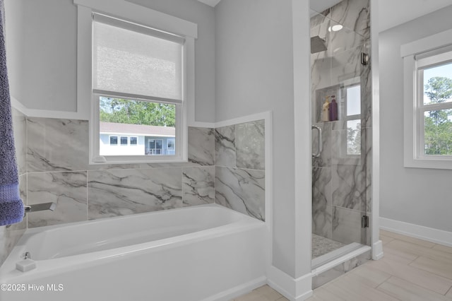 1246 Heron Run Dr, Wilmington, NC 28403 - full bathroom with a garden tub, a marble finish shower, and baseboards