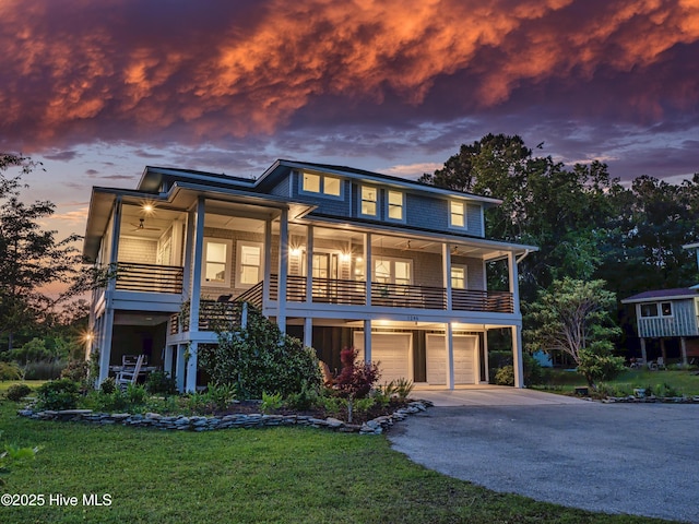1246 Heron Run Dr, Wilmington, NC 28403 - view of front facade featuring an attached garage, asphalt driveway, and a front yard