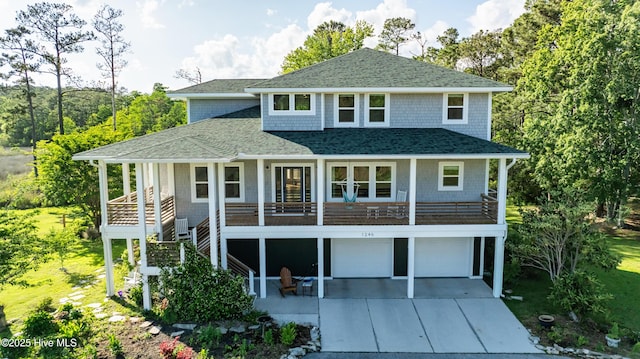 1246 Heron Run Dr, Wilmington, NC 28403 - view of front of property with a shingled roof, driveway, a garage, and a porch