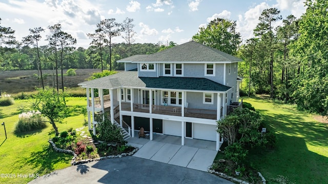 1246 Heron Run Dr, Wilmington, NC 28403 - rear view of property with driveway, a garage, a yard, stairs, and roof with shingles