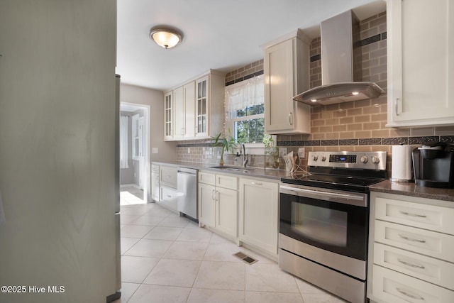 1206 Lancaster Ln, Rockingham, NC 28379 - kitchen with stainless steel appliances, wall chimney exhaust hood, a sink, tasteful backsplash, and glass insert cabinets