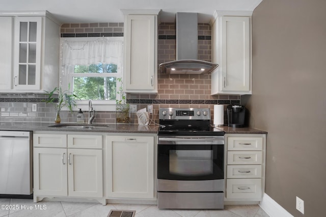 1206 Lancaster Ln, Rockingham, NC 28379 - kitchen featuring stainless steel range with electric stovetop, dishwasher, wall chimney range hood, a sink, and backsplash