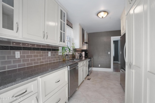 1206 Lancaster Ln, Rockingham, NC 28379 - kitchen with dishwasher, a sink, glass insert cabinets, backsplash, and white cabinetry