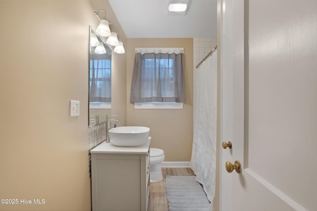1206 Lancaster Ln, Rockingham, NC 28379 - full bathroom featuring vanity, toilet, wood finished floors, baseboards, and a shower with curtain