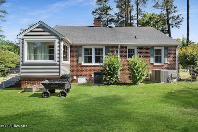 1206 Lancaster Ln, Rockingham, NC 28379 - back of property featuring central air condition unit, a chimney, roof with shingles, and brick siding