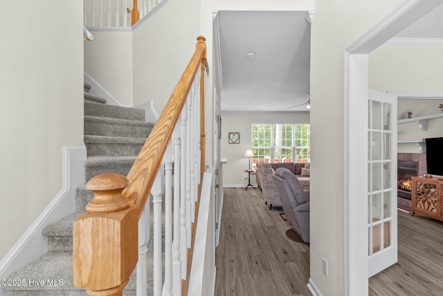 154 Dockside Dr, Jacksonville, NC 28546 - stairway featuring wood finished floors, a tiled fireplace, and baseboards