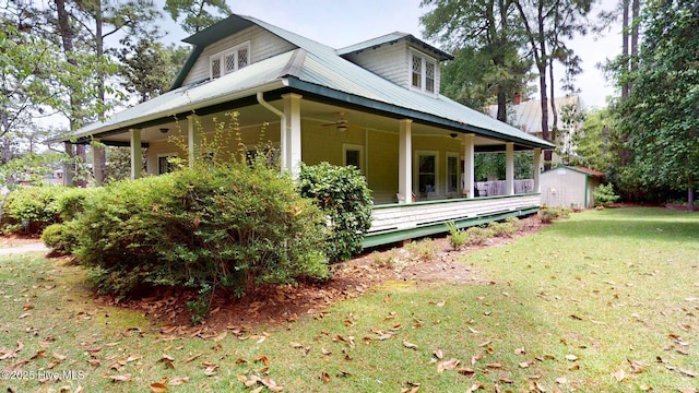 305 E New Hampshire Ave, Southern Pines, NC 28387 - view of home's exterior with a ceiling fan, a lawn, and metal roof