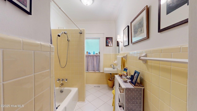 305 E New Hampshire Ave, Southern Pines, NC 28387 - bathroom featuring tile patterned flooring, tub / shower combination, tile walls, crown molding, and a sink