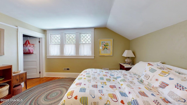 305 E New Hampshire Ave, Southern Pines, NC 28387 - bedroom featuring wood finished floors, lofted ceiling, and baseboards