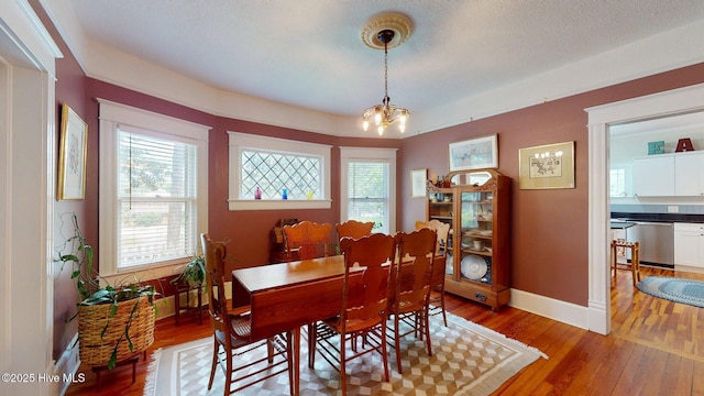 305 E New Hampshire Ave, Southern Pines, NC 28387 - dining space with light wood finished floors, baseboards, and a chandelier