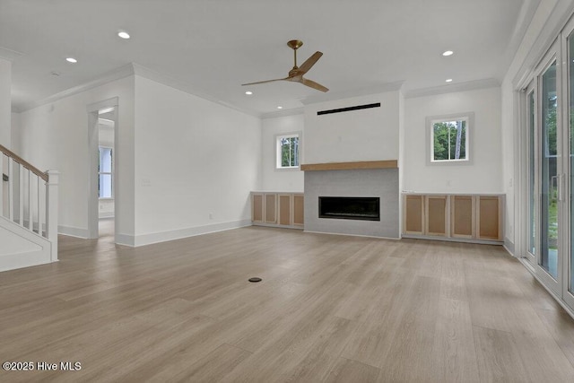 324 Grayhawk Cir, Wilmington, NC 28411 - unfurnished living room with ornamental molding, light wood-style floors, a fireplace, stairs, and a ceiling fan