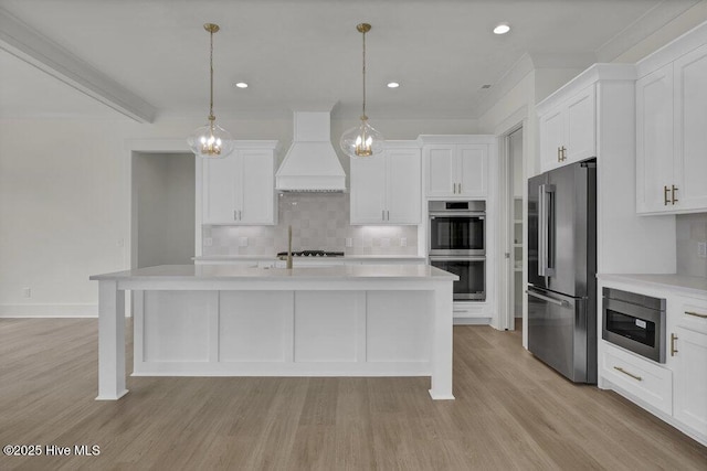 324 Grayhawk Cir, Wilmington, NC 28411 - kitchen featuring stainless steel appliances, custom range hood, light countertops, backsplash, and recessed lighting