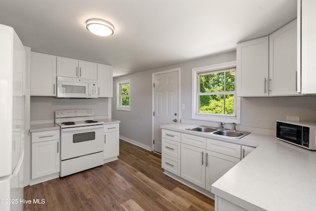 13271 US Highway 17, Hampstead, NC 28443 - kitchen featuring white appliances, a sink, light countertops, dark wood finished floors, and white cabinets