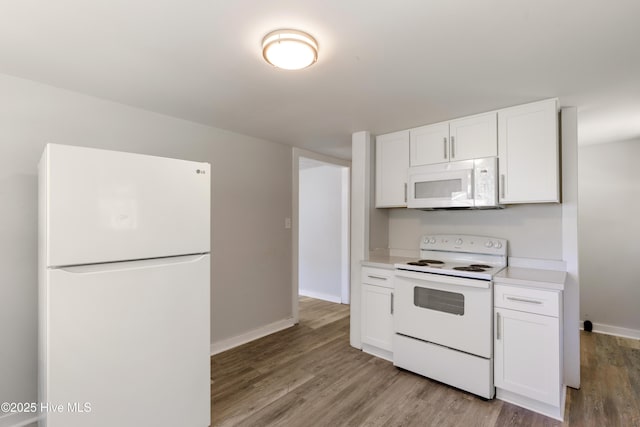 13271 US Highway 17, Hampstead, NC 28443 - kitchen featuring white appliances, light wood-style floors, white cabinetry, baseboards, and light countertops