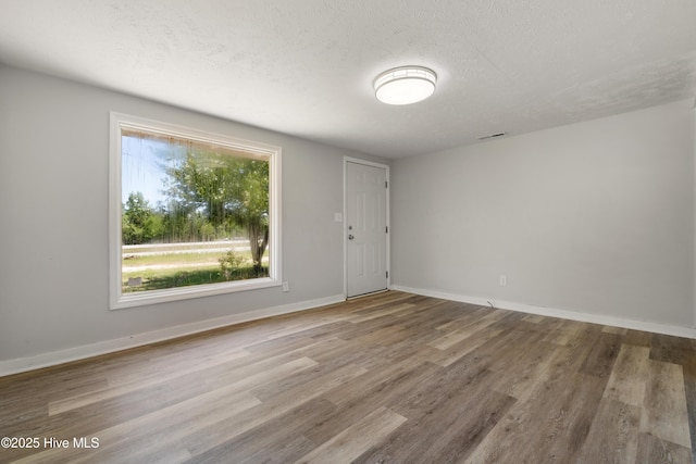 13271 US Highway 17, Hampstead, NC 28443 - empty room with wood finished floors, baseboards, and a textured ceiling