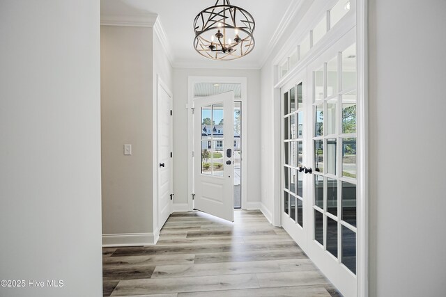 947 Ashburton Rd SE, Bolivia, NC 28422 - foyer entrance with ornamental molding, a chandelier, french doors, wood finished floors, and baseboards