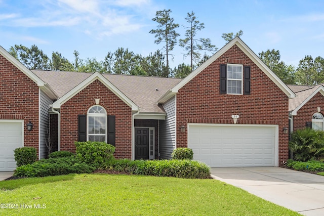 94 Field Planters Cir, Calabash, NC 28467 - traditional home featuring a front lawn, brick siding, concrete driveway, a shingled roof, and a garage