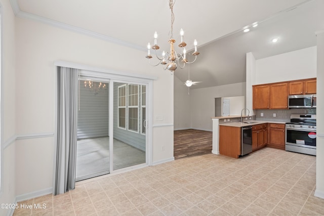 94 Field Planters Cir, Calabash, NC 28467 - kitchen featuring stainless steel appliances, a chandelier, a peninsula, brown cabinets, and a sink