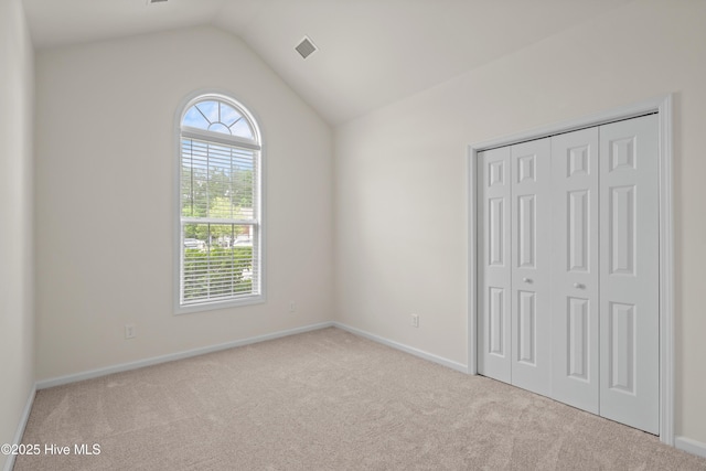 94 Field Planters Cir, Calabash, NC 28467 - unfurnished bedroom with carpet, lofted ceiling, baseboards, and a closet
