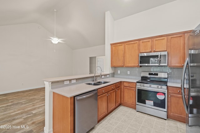 94 Field Planters Cir, Calabash, NC 28467 - kitchen featuring stainless steel appliances, a sink, light countertops, backsplash, and high vaulted ceiling