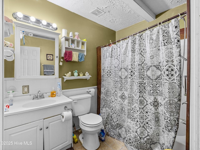 323 Alexander Rouse Rd, Kinston, NC 28504 - full bathroom featuring vanity, toilet, a textured ceiling, tile patterned floors, and a shower with curtain